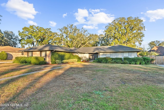 ranch-style house with a front lawn