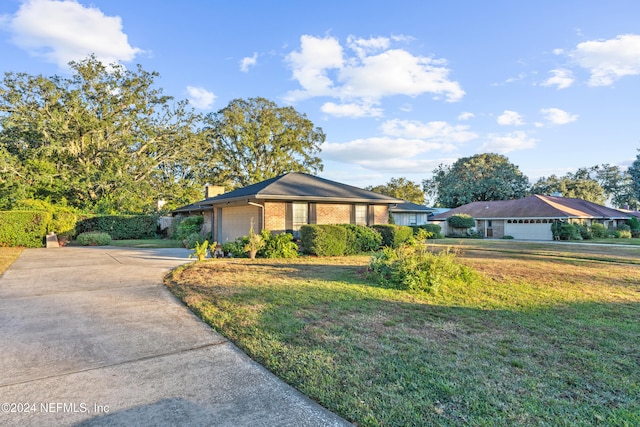 ranch-style home with a front lawn and a garage