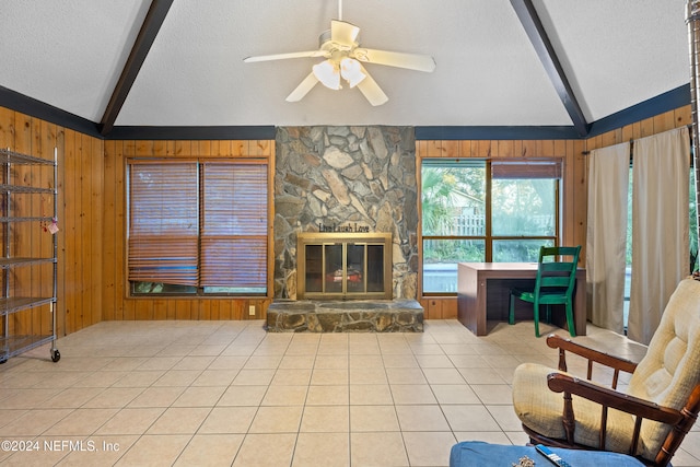 living room featuring vaulted ceiling with beams and wood walls