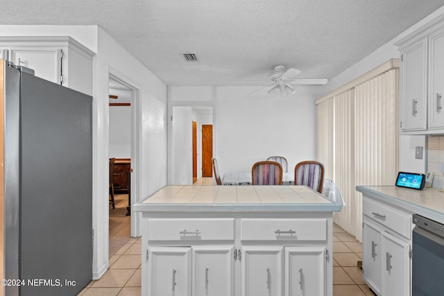 kitchen featuring appliances with stainless steel finishes, white cabinetry, and ceiling fan