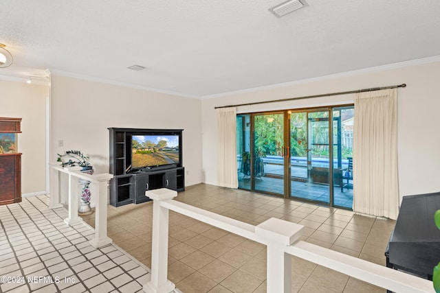 tiled living room featuring a textured ceiling and ornamental molding