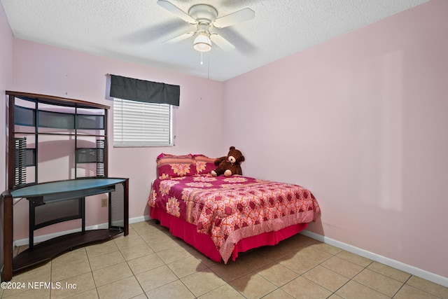 tiled bedroom featuring a textured ceiling and ceiling fan