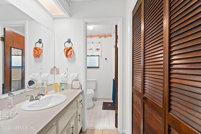 bathroom featuring tile patterned floors, vanity, and toilet