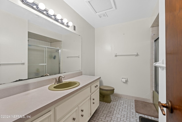 full bathroom with tile patterned flooring, vanity, toilet, and bath / shower combo with glass door