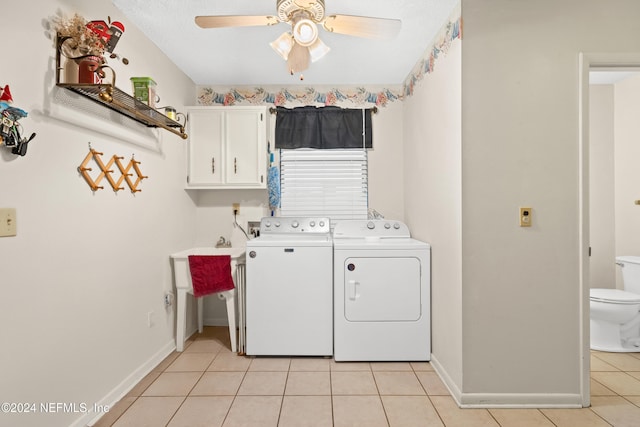 laundry area with washing machine and clothes dryer, ceiling fan, cabinets, a textured ceiling, and light tile patterned floors