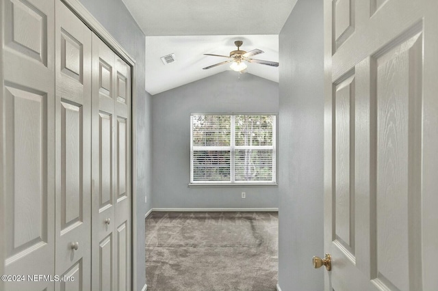 bedroom with light carpet, a closet, vaulted ceiling, and ceiling fan