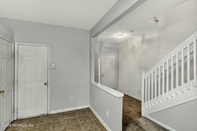 foyer entrance featuring dark tile patterned flooring