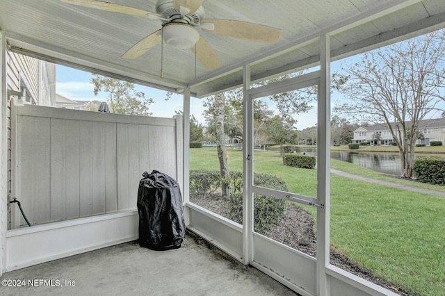 sunroom / solarium featuring a water view, a wealth of natural light, and ceiling fan