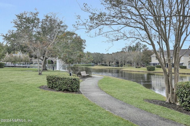 view of property's community featuring a water view and a lawn