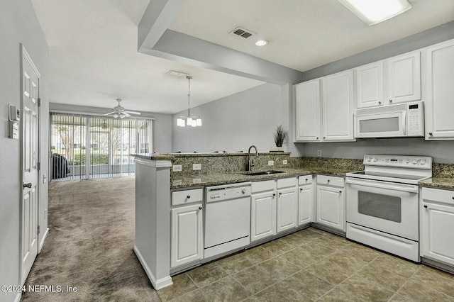 kitchen featuring white appliances, light carpet, white cabinets, sink, and kitchen peninsula