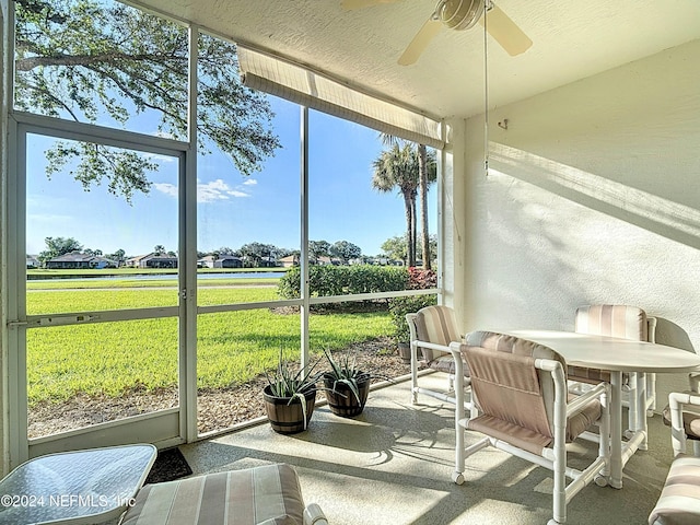 sunroom featuring ceiling fan and a healthy amount of sunlight