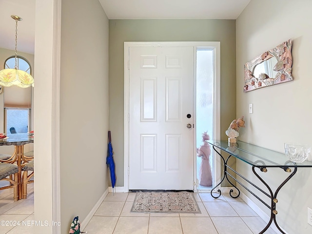 foyer with light tile patterned floors and a healthy amount of sunlight