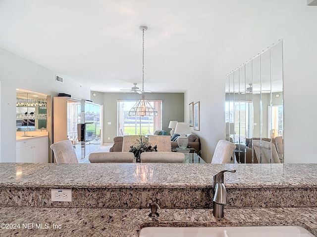 kitchen featuring ceiling fan and sink