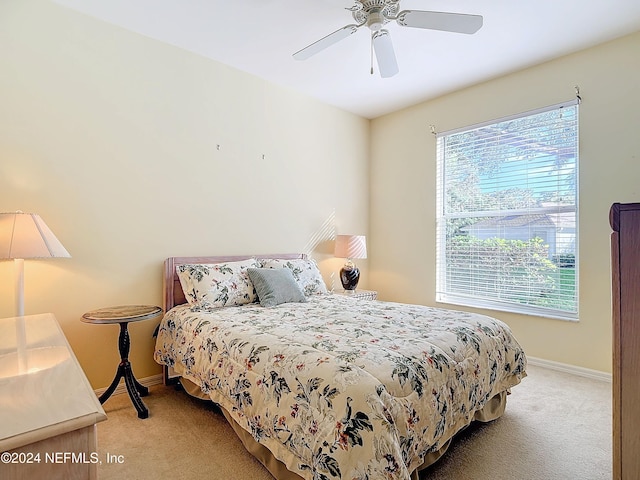 bedroom with light carpet and ceiling fan