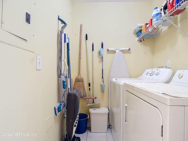 clothes washing area featuring washing machine and clothes dryer and light tile patterned floors