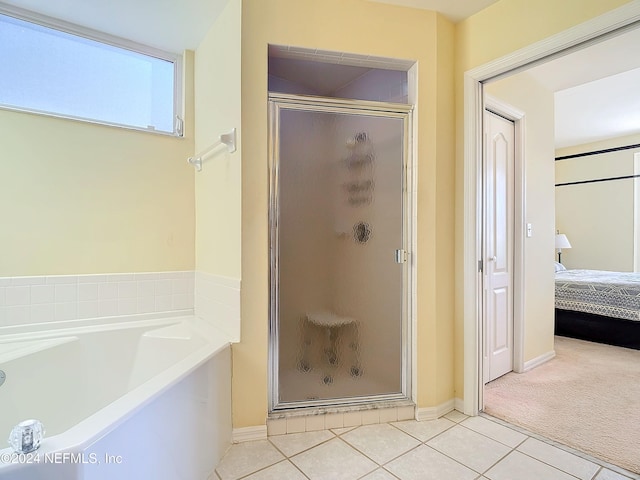 bathroom featuring tile patterned flooring and plus walk in shower