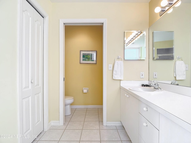 bathroom featuring tile patterned floors, vanity, and toilet