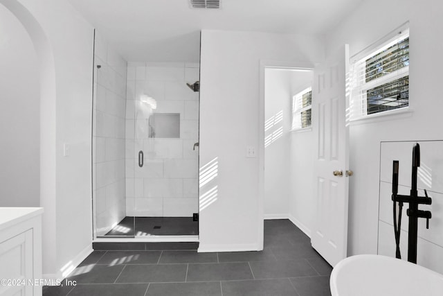 bathroom featuring separate shower and tub, tile patterned flooring, and vanity