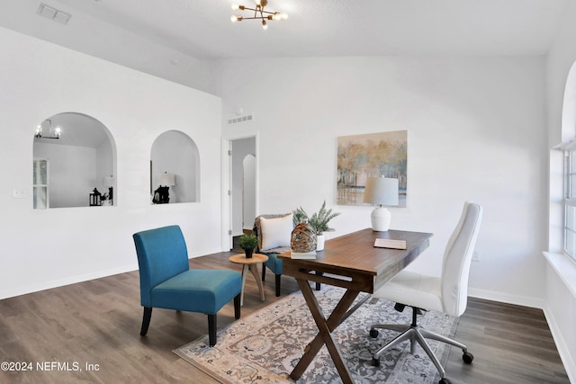 office featuring dark hardwood / wood-style floors, high vaulted ceiling, and a chandelier