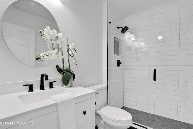 bathroom featuring vanity, toilet, and walk in shower