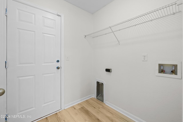 laundry area with hardwood / wood-style floors and washer hookup