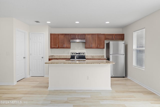 kitchen featuring an island with sink, light hardwood / wood-style floors, and appliances with stainless steel finishes