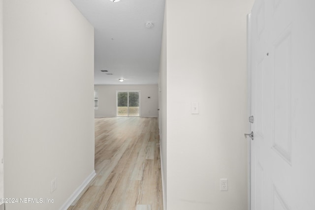 corridor featuring light hardwood / wood-style floors