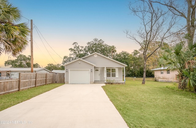 view of front facade featuring a garage and a lawn