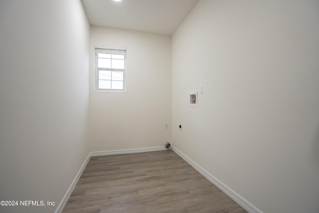 laundry area featuring washer hookup, light hardwood / wood-style flooring, and electric dryer hookup