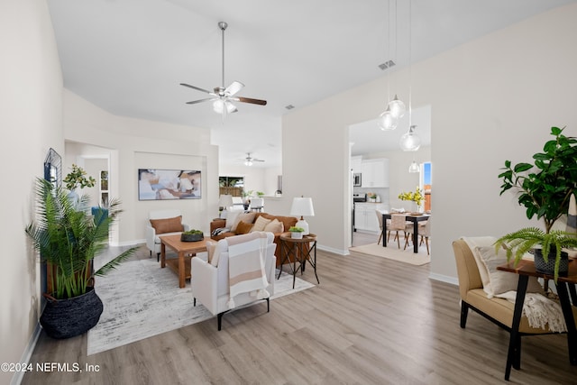 living room featuring ceiling fan and light wood-type flooring