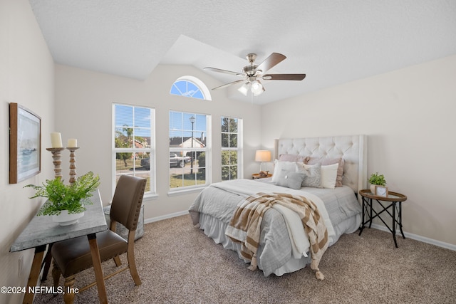 carpeted bedroom with ceiling fan and vaulted ceiling