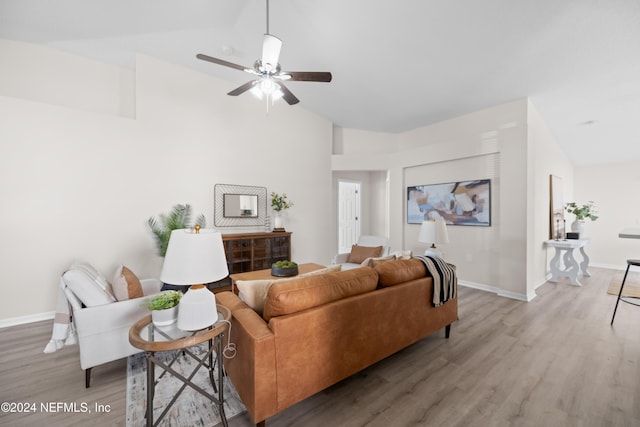 living room with hardwood / wood-style floors, ceiling fan, and lofted ceiling