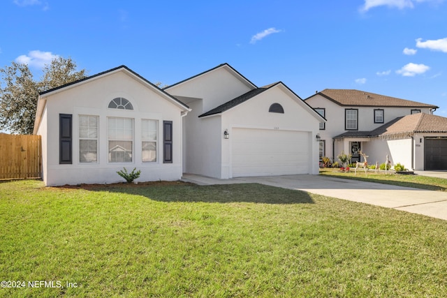 view of front of property with a garage and a front yard