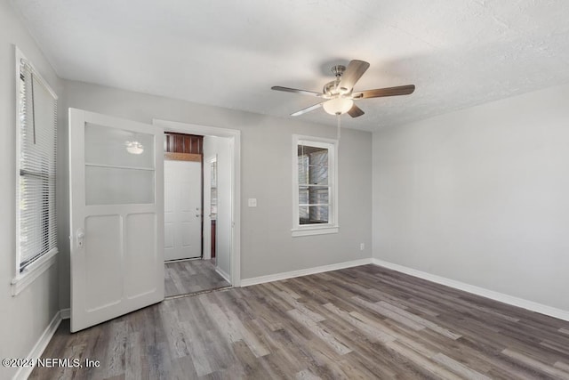 empty room featuring ceiling fan and hardwood / wood-style flooring