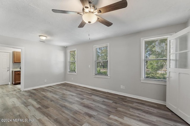 unfurnished room featuring ceiling fan and dark hardwood / wood-style floors