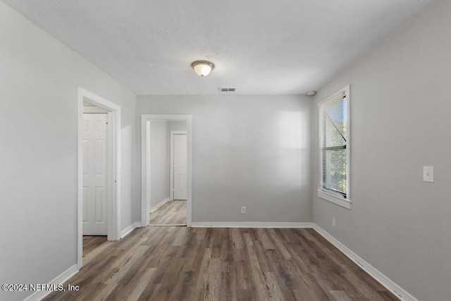 empty room with dark wood-type flooring