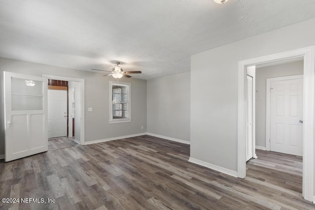 empty room with ceiling fan and wood-type flooring