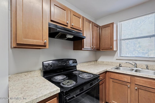 kitchen featuring black range with electric stovetop and sink