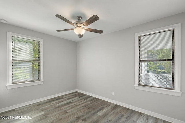 spare room featuring hardwood / wood-style flooring, plenty of natural light, and ceiling fan