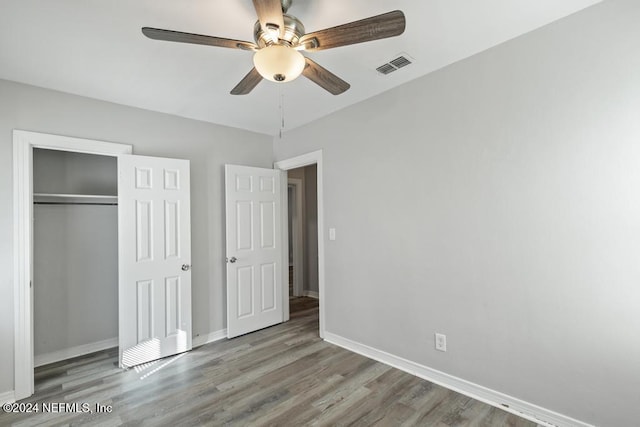 unfurnished bedroom featuring ceiling fan, a closet, and light hardwood / wood-style floors