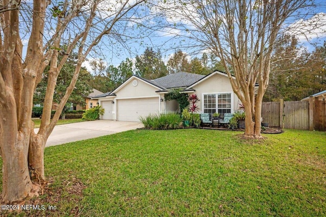 ranch-style house featuring a garage and a front lawn