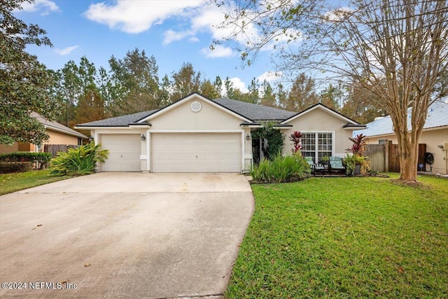 single story home with a garage and a front lawn