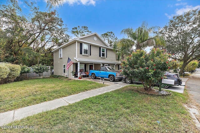 view of front of home with fence and a front yard