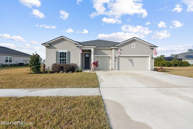 single story home with a garage and a front lawn