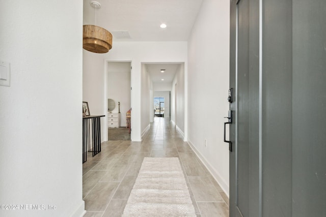 corridor featuring light tile patterned flooring