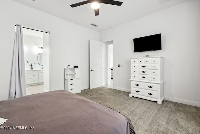 carpeted bedroom with ceiling fan and ensuite bathroom