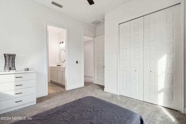 unfurnished bedroom with light colored carpet, ensuite bath, a closet, and ceiling fan