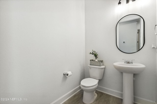 bathroom featuring sink, toilet, and hardwood / wood-style flooring