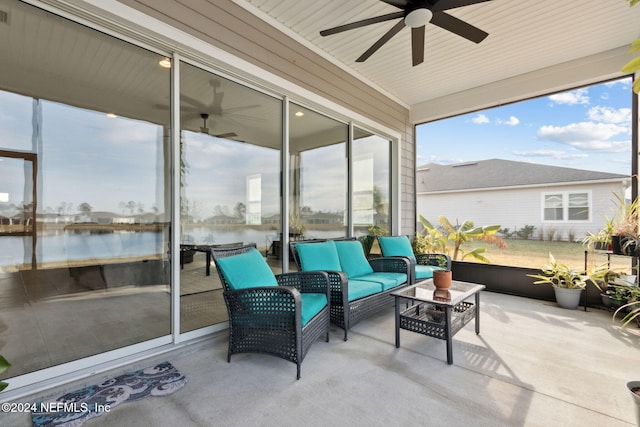 sunroom with a water view and ceiling fan