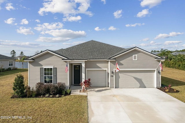 ranch-style home featuring a front lawn and a garage